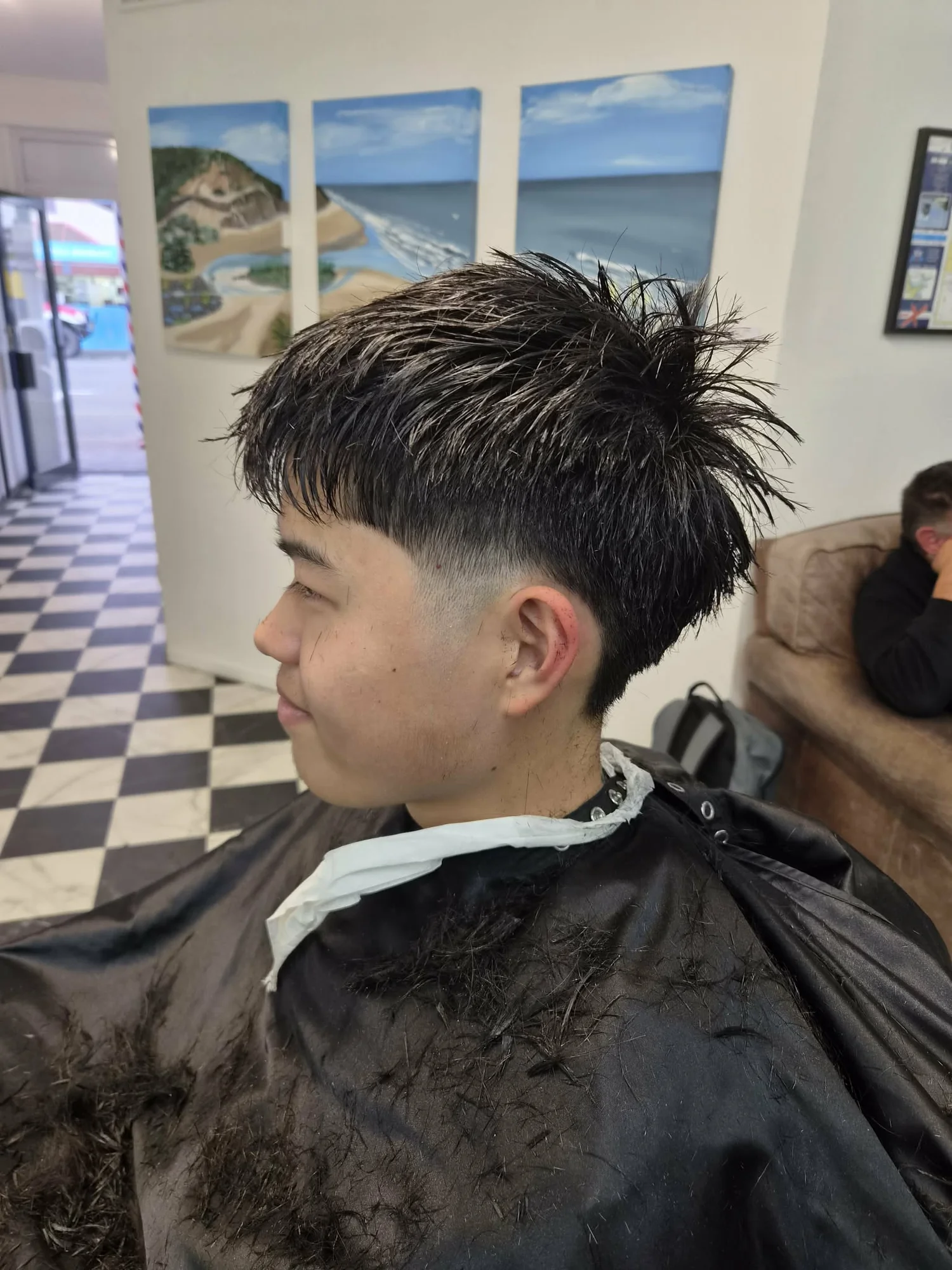 Fade haircut with the Monk Street storefront visible through the doorway